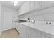 Laundry room with washer, dryer, and built-in shelving at 19148 Dove Creek Dr, Tampa, FL 33647