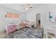 Bedroom with twin beds, ceiling fan, and plenty of light at 19148 Dove Creek Dr, Tampa, FL 33647