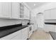 Modern kitchen featuring white cabinets and dark countertops at 19148 Dove Creek Dr, Tampa, FL 33647