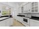 Bright kitchen with white cabinets, black countertops, and modern appliances at 19148 Dove Creek Dr, Tampa, FL 33647