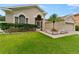 Landscaped front yard with a spacious driveway and a lovely palm tree at 19148 Dove Creek Dr, Tampa, FL 33647