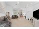 Open living room with neutral decor and a view into the dining area at 19148 Dove Creek Dr, Tampa, FL 33647