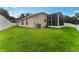 Spacious backyard with grassy area and screened porch at 19148 Dove Creek Dr, Tampa, FL 33647