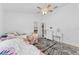 Bedroom with twin beds, ceiling fan, dresser, and rug at 19148 Dove Creek Dr, Tampa, FL 33647