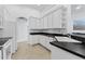Kitchen with white cabinets, dark countertops, and a corner sink at 19148 Dove Creek Dr, Tampa, FL 33647