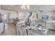Open concept dining area with a farmhouse table and view into the kitchen and living room at 18227 Fattoria Ter, Lakewood Ranch, FL 34211