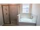 Bathroom showcasing a glass-enclosed shower and a separate soaking tub at 18142 Beach Ranch Ter, Lakewood Ranch, FL 34211