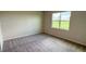 Bright bedroom with neutral carpet, a large window and scenic backyard views at 18142 Beach Ranch Ter, Lakewood Ranch, FL 34211