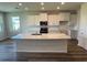 An open kitchen with an island, complete with white cabinets, modern appliances, and countertops at 18142 Beach Ranch Ter, Lakewood Ranch, FL 34211
