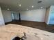 A wide shot of a living room featuring recessed lights and light, wood-look floors at 18142 Beach Ranch Ter, Lakewood Ranch, FL 34211