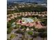 Bird's eye view of neighborhood pool and clubhouse surrounded by lush trees, landscaping, and homes at 227 Mystic Falls Dr, Apollo Beach, FL 33572