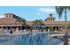Relaxing community pool area with ample seating, umbrellas, and meticulously kept grounds at clubhouse at 227 Mystic Falls Dr, Apollo Beach, FL 33572