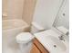 Clean bathroom with tub, toilet and wood vanity at 227 Mystic Falls Dr, Apollo Beach, FL 33572