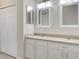 Double vanity bathroom with neutral countertops and white cabinets at 227 Mystic Falls Dr, Apollo Beach, FL 33572