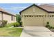 Tan villa with two-car garage, landscaping, and walkway at 227 Mystic Falls Dr, Apollo Beach, FL 33572