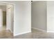 A long hallway with access to the bathroom and neutral decor at 227 Mystic Falls Dr, Apollo Beach, FL 33572