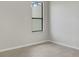 Empty bedroom with tile floors and a large window at 227 Mystic Falls Dr, Apollo Beach, FL 33572