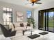 Bright living room with beige sofa, and sliding doors leading to the patio at 227 Mystic Falls Dr, Apollo Beach, FL 33572