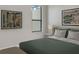 Bedroom with green bedding, two framed artworks, and a window at 227 Mystic Falls Dr, Apollo Beach, FL 33572