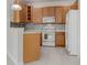 Bright kitchen with light wood cabinets, tile backsplash, and modern appliances at 227 Mystic Falls Dr, Apollo Beach, FL 33572