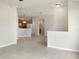 Open living room with tile floors and views into kitchen area at 227 Mystic Falls Dr, Apollo Beach, FL 33572