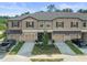 Three townhouses with garages and landscaping at 8491 Essington St, New Port Richey, FL 34654