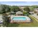 Community pool with a covered patio and lounge chairs at 8491 Essington St, New Port Richey, FL 34654