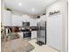 Stylish kitchen with stainless steel appliances and granite countertops at 8491 Essington St, New Port Richey, FL 34654