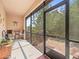 Relaxing screened patio with table, chairs, and grill, overlooking a wooded area at 8491 Essington St, New Port Richey, FL 34654