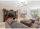 Open living room with a sectional sofa and large TV at 8491 Essington St, New Port Richey, FL 34654