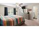 Bright bedroom featuring a king-size bed and ensuite bathroom at 8491 Essington St, New Port Richey, FL 34654