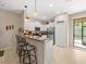Bright kitchen featuring granite countertops and white cabinetry at 8491 Essington St, New Port Richey, FL 34654