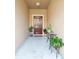 Inviting entryway with potted plants and a wooden door at 8491 Essington St, New Port Richey, FL 34654