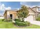 Tan house exterior with landscaping and stone accents at 1515 Gadsden Point Pl, Ruskin, FL 33570