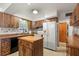 Kitchen with wood cabinets, island, and access to Gathering room at 1213 E Frierson Ave, Tampa, FL 33603