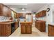 Kitchen features wood cabinets, an island, and ample counter space at 1213 E Frierson Ave, Tampa, FL 33603