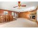 Open living area showcasing a stone fireplace and wood paneling at 1213 E Frierson Ave, Tampa, FL 33603