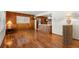 Spacious living area with wood-paneled walls and laminate floors at 1213 E Frierson Ave, Tampa, FL 33603