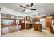 Open kitchen with wood cabinets, island, and access to backyard at 1213 E Frierson Ave, Tampa, FL 33603