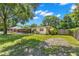 Side yard view of charming ranch home with large lawn at 1213 E Frierson Ave, Tampa, FL 33603