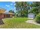 Spacious backyard with grassy area and storage sheds at 1213 E Frierson Ave, Tampa, FL 33603