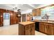 Kitchen offers wood cabinets, an island, and a breakfast bar at 1213 E Frierson Ave, Tampa, FL 33603