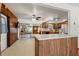 Kitchen boasts wood cabinets, an island, and views of the living room at 1213 E Frierson Ave, Tampa, FL 33603