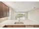 Kitchen island with sink and view into Gathering room and pool at 4838 Sevilla Shores Dr, Wimauma, FL 33598