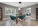 Stylish dining area with glass table, teal chairs, and modern pendant lighting at 1322 E Norfolk St, Tampa, FL 33604