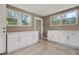 Spacious laundry room with tiled floors, white cabinetry, washer, and dryer at 1322 E Norfolk St, Tampa, FL 33604