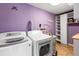 Laundry room with washer, dryer, shelving, and water heater at 3625 W Tampa Cir, Tampa, FL 33629