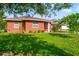 Brick home with lush landscaping and a walkway at 3625 W Tampa Cir, Tampa, FL 33629