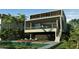 Two-story modern home with a pool and wooden deck at 1725 Gulf Rd, Tarpon Springs, FL 34689