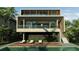 Two-story modern home with a pool and wooden deck at 1725 Gulf Rd, Tarpon Springs, FL 34689